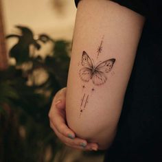 a woman's arm with a butterfly tattoo on the left side of her body