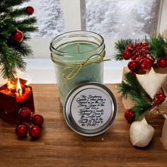 a candle and some christmas decorations on a table