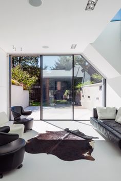 an open living room with black and white furniture