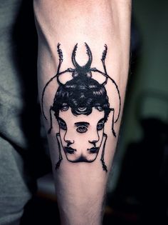 a man with a spider tattoo on his leg and head is shown in black ink