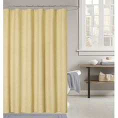 a yellow shower curtain in a bathroom