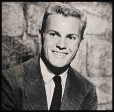 a black and white photo of a man in a suit