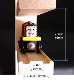 a toy thomas the tank engine is shown with measurements for it's size and height