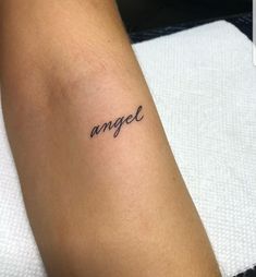 a woman's arm with the word angel tattooed on her left forearm and an inscription in cursive font