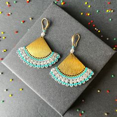 These earrings epitomize craftsmanship, utilizing top-tier branded beads such as Miyuki Delica beads and TOHO seed beads. Meticulously handcrafted with a robust beading thread, these earrings guarantee enduring shape retention and bead stability, even with continuous wear. A diverse spectrum of color combinations is available to cater to individual preferences, while all metallic components are expertly fashioned from high-quality brass. Hypoallergenic earring hooks prioritize wearer comfort and safety. Each design in the shop reflects a profound commitment to artistry, characterized by painstaking attention to detail.  Importantly, please consider potential slight variations in product color due to lighting and monitor calibration. Recommended care guidelines include precautions against w Gold Festive Earrings With Tiny Beads, Festive Gold Earrings With Tiny Beads, Brass Beaded Earrings With Tiny Beads As Gift, Brass Beaded Earrings As Gift, Brass Beaded Earrings For Gifts, Gold Earrings With Tiny Beads For Gifts, Traditional Gold Earrings With Tiny Beads, Handmade Gold Beaded Drop Earrings, Handmade Metal Beaded Earrings For Festive Occasions