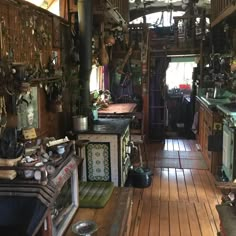 an old fashioned kitchen with wood floors and lots of clutter on the counter top