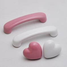 three heart shaped erasers sitting next to each other