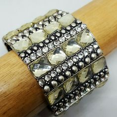 Bands Of Pale Yellow Crystals, Clear Rhinestones And Silver Nail Heads Course Around This Wide Cuff Bracelet. 0 Yellow Rhinestone Jewelry For Party, Yellow Rhinestone Party Jewelry, Yellow Jeweled Jewelry For Party, Elegant Yellow Jewelry With Rhinestones, Gold Crystal Bracelet With Stones For Party, Gold Crystal Party Bracelet With Stones, Gold Crystal Bracelet For Party, Yellow Metal Bangle Bracelet, Elegant Adjustable Yellow Cuff Bracelet