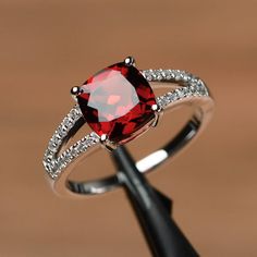 It is a real natural garnet ring. The main stone is 8mm*8mm cushion cut garnet, weight about 2.71 carats The basic metal is sterling silver and plated with rhodium. To change the metal to a solid gold (white/rose) or platinum is also available, please ask for a quotation if you want. You can also go to my shop Home for more elegant rings: https://www.etsy.com/shop/godjewelry?ref=hdr_shop_menu Garnet is the birthstone of January. More garnet rings: https://www.etsy.com/shop/godjewelry?ref=hdr_sho Ruby Solitaire Ring Engagement, Ruby Ring Designs, Ruby Solitaire Ring, Red Gemstone Ring, 1950s Jewelry, July Birthstone Ring, January Birthstone Rings, Garnet Engagement Ring, Dark Wedding