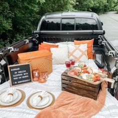 a truck bed with food and drinks on it