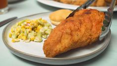 a plate with fried chicken, macaroni and cheese on it