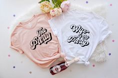 two t - shirts with the words wife and husband printed on them next to a bottle of wine