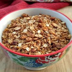 a bowl filled with granola sitting on top of a wooden table