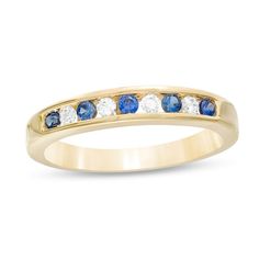 Seal your vows with this unique gemstone and diamond wedding band. Crafted in 14K gold, this interesting style showcases channel-set bright blue sapphires alternating with shimmering diamonds. Captivating with 1/8 ct. t.w. of diamonds and a brilliant buffed luster, this wedding band is the start of something beautiful. Blue Sapphire Ring With Half Eternity Diamond Setting, Anniversary Sapphire Jewelry With Side Stones, Blue Sapphire Half Eternity Ring In 14k Gold, Yellow Gold Sapphire Ring With Channel Set Diamond, Anniversary Yellow Gold Sapphire Ring With Channel Set, Yellow Gold Sapphire Ring With Pave Setting, Gold Sapphire Jewelry With Channel Set, Blue Diamond Ring Channel Set, Blue Diamond Ring With Channel Setting