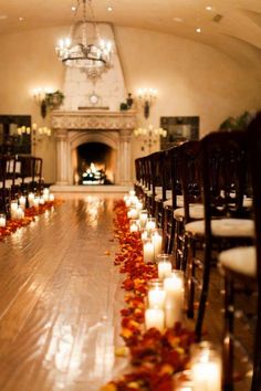 the aisle is lined with candles and rose petals