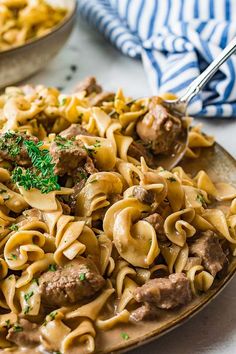 a plate full of pasta with meat and sauce