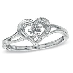 a heart shaped ring with two diamonds on it's sides, set in 18k white gold