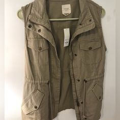 Francesca’s Harper Brand Army Green Vest/Sleeveless Jacket. Brand New. Sleeveless Spring Outerwear With Pockets, Sleeveless Outerwear With Pockets For Spring, Khaki Vest For Ladies For Fall, Spring Khaki Vest Outerwear, Sleeveless Utility Vest For Spring, Spring Sleeveless Utility Vest, Sleeveless Khaki Outerwear For Spring, Fall Khaki Vest Top, Khaki Sleeveless Outerwear For Spring