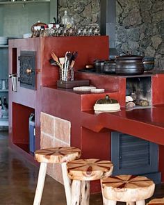 two stools are sitting in front of a stove and counter top with pots on it