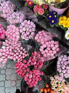 colorful flowers are arranged on display for sale