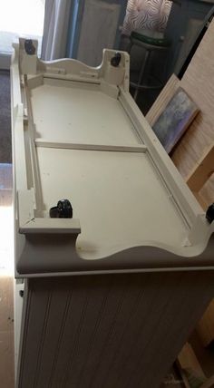 a kitchen counter top with an open drawer on the bottom and two knobs in the middle