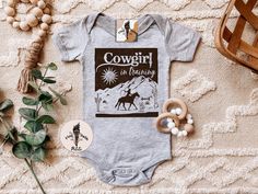 "COWGIRL IN TRAINING (baby bodysuit or kids tee): Designed and handmade in Phoenix - ▲Designed and handmade in Phoenix.▲ ▲The \"PETITE\" kids/baby sister shop of THE PINE TORCH® - our main shop with over 100,000 sales and 25,000 5 star reviews - since 2015! ▲ https://www.etsy.com/shop/ThePineTorch 🌈YEEHAW! Cowgirl in training! How adorable is this retro cowgirl theme design? Perfect for a pregnancy announcement, newborn baby gift, first rodeo top, and beyond! * * * * * * * * * * * * * * * * * * Fitted Short Sleeve Onesie With Custom Print, Cute Fitted Pre-shrunk Onesie, Cute Fitted Onesie With Custom Print, Cowgirl Baby, Phoenix Design, Kids Holiday Gifts, Baby Sister, Newborn Baby Gifts, Holidays With Kids