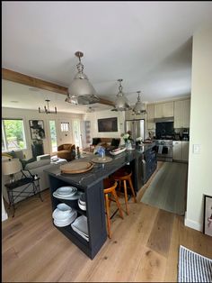 a large kitchen with an island in the middle and lots of plates on top of it