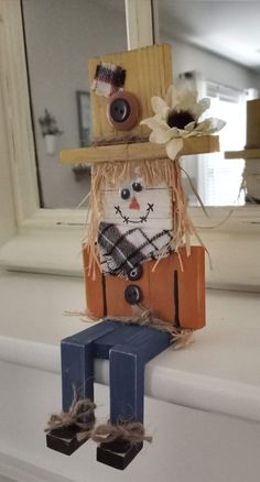 a scarecrow is sitting on top of a shelf