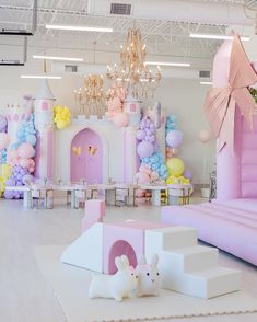 a room decorated in pastel colors and balloons