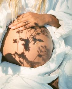 a pregnant woman's shadow on her stomach