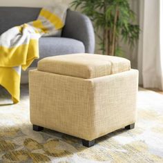 a living room with a couch, chair and ottoman