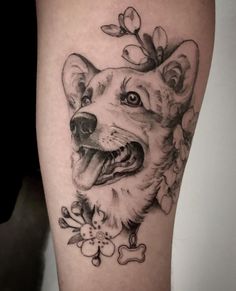 a black and white photo of a dog's face with flowers on its head