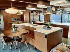 a large kitchen with an island and dining room table