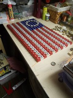 an american flag made out of cans sitting on top of a table next to other items