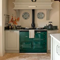 an old fashioned green stove in a white kitchen