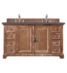 a bathroom vanity with two sinks and three faucets on the top, in light wood