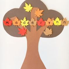 an autumn tree made out of paper with the word madelyn spelled in leaves on it