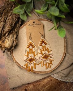 ⋄ These handwoven earrings are inspired by the Southwest and add flair to any outfit. They will grab attention with their beautiful colors and intricate design. Each pair is made with love and care, ensuring that you get a unique and high-quality product that you can cherish for years to come! ⋄ ⋄⋄Over 1,500 individual beads used⋄⋄ Colors used: ⋄Matte Opaque Cream ⋄Dyed Opaque Pumpkin  ⋄Dyed Matte Opaque Sienna Materials used:  ⋄Miyuki Delica 11/0 Matte Seed Beads ⋄14x27mm Earwire with Ball ⋄Nymo Nylon Thread ⋄Beeswax to coat the thread Dimensions: ⋄Drop Length 3.5 inches ⋄Length 4 inches ⋄Width 1.25 inches Cheap Southwestern Beaded Earrings For Festival, Affordable Southwestern Beaded Earrings For Festivals, Cheap Handmade Southwestern Beaded Earrings, Western Beaded Earrings Simple, Cheap Multicolor Southwestern Beaded Earrings, Making Seed Bead Earrings, Southwest Beaded Earrings, Western Beaded Fringe Earrings, Native Fringe Earrings