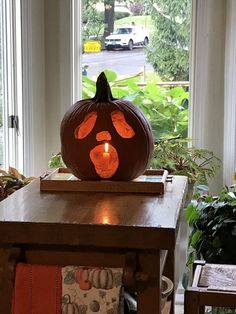 a carved pumpkin sitting on top of a wooden table