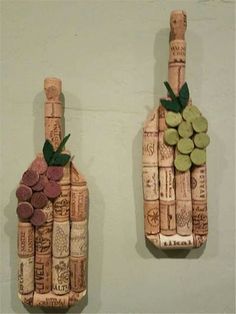 two wine bottles made out of corks with grapes and leaves on the top one