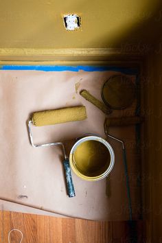 Process photo of room being painted a deep ochre yellow