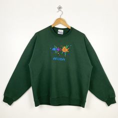 90s Aruba Crewneck Sweatshirt Embroidery Logo Green Color Men's L - Made in Usa - Materials : Cotton, Polyester  - Tag Reads : L Kindly see the actual measurements (All measurements were taken lying flat) - Actual size manual measurements * Width (Armpit to armpit) : 23 inches * Length (Shoulder to end of garment) : 26 inches * Sleeve length : 22.5 inches - Condition : * Vintage condition 8/10 (80%) * Minor stain refer picture  * Free from tear and major defect - Shipping : * DHL EXPRESS = 3-6 business day arrived * Please PROVIDE your PHONE/CONTACT NUMBER for SHIPPING/DELIVERY purpose DON'T FORGET TO VISIT MY SHOP FOR MORE GREAT STUFF, THANK YOU. Embroidered Green Tops For Streetwear, Green Embroidered Streetwear Sweatshirt, 90s Embroidered Long Sleeve Sweatshirt, 90s Embroidered Winter Tops, 90s Embroidered Fall Sweatshirt, American Vintage Clothing, Nike Crewneck Sweatshirt, Sweatshirt Embroidery, Nike Crewneck