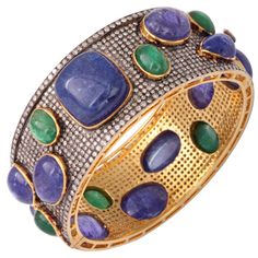 This impressive bangle is beautifully made with over 12 carats of diamonds, over 18 carats in emeralds, and over 28 carats in tanzanites. Interior measures 2 3/8" by 2 1/16". The interior circumference is 7". Pave Bangle, Vintage Bangles, Diamond Brooch, Diamond Bangle, Fantasy Jewelry, Cuff Bangles, Natural Pearls, Gold Bangles, Pave Diamonds