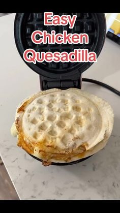 an easy chicken quesadilla in a waffle iron on top of a counter