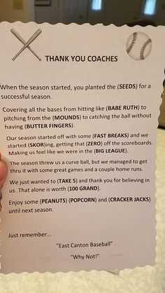 a person holding up a baseball coach's thank note