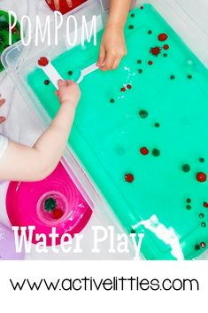 a toddler is playing with water play