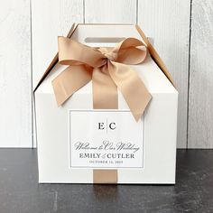 a white box with a brown ribbon on it