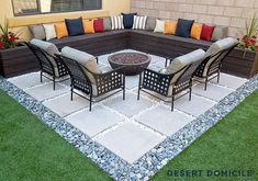 an outdoor living area with couches, chairs and a fire pit in the middle