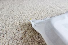 a piece of white fabric is laying on the floor with it's end torn off