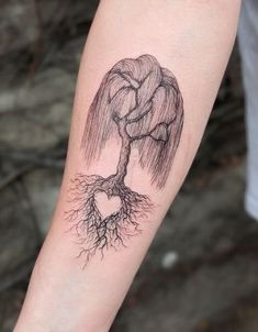 a person with a tattoo on their arm has a tree growing out of it's roots